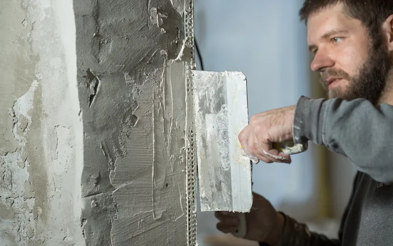 Floating plaster against a metal bead at a wall edge