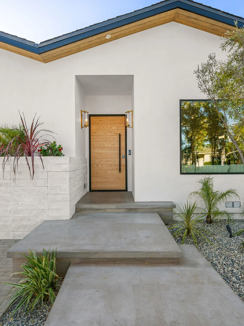 White stucco home with drought-tolerant landscaping